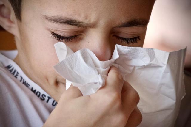 Gambar seseorang yang sedang bersin, ilustrasi cara mengatasi hidung meler dengan cepat.